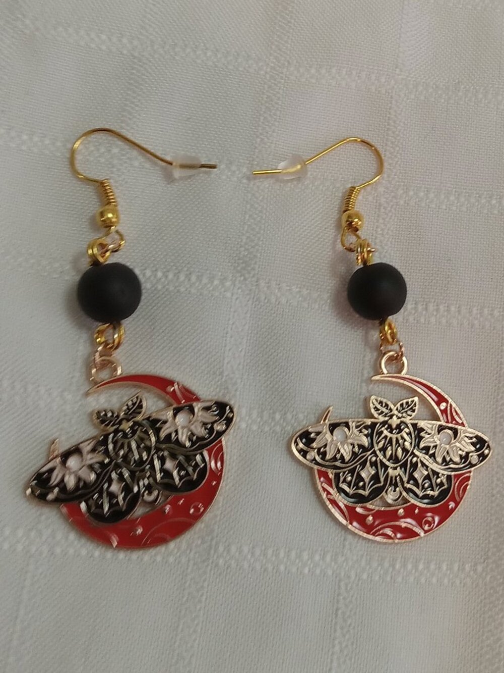 Handmade gold-colored earrings with multicolored enameled butterflies and beads